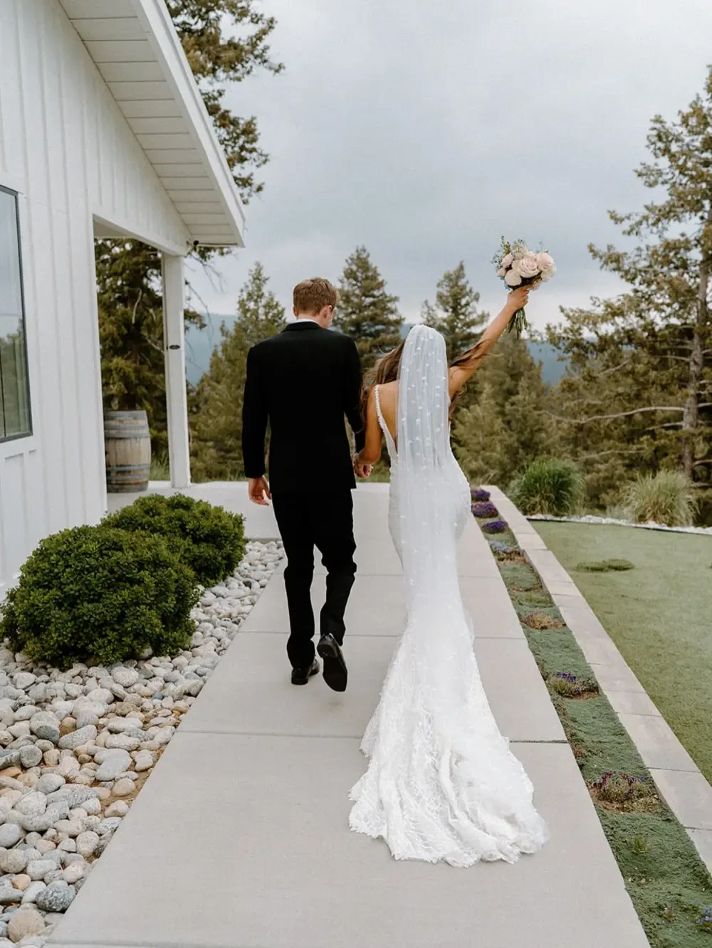 Сouple wearing a white gown and a black suit